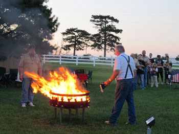 Allen Porter adding his flag to the cauldron