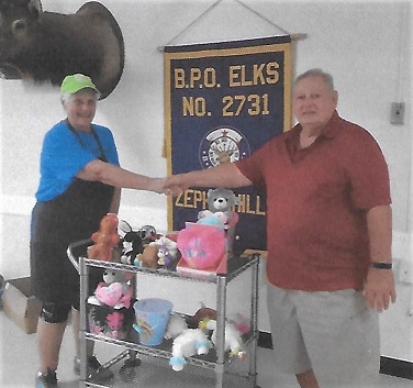 The Zephyrhills Elks Lodge Veterans Committee has donated toys to the Feed the Kids Program. Pictured are PER Donna Moyer (L) and PER Ken Fabiani (Veterans Committee Chair).