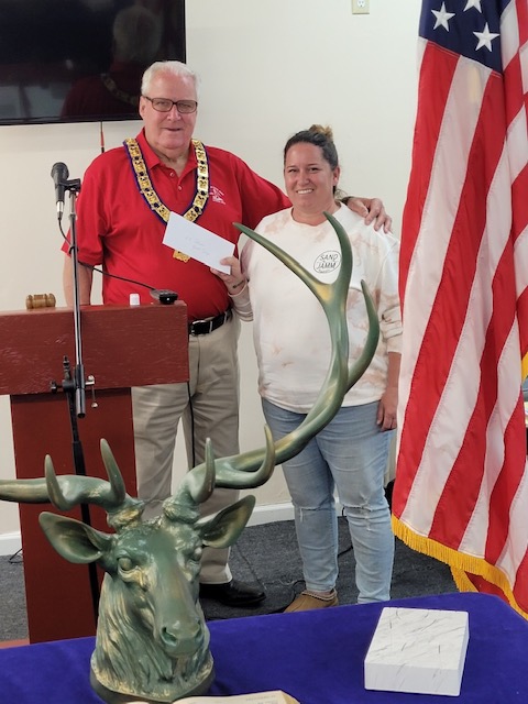 ER Denny Lennon presents a $1500 check to Lower Township Police Corporal Jennifer Elwell to help fund the Police Summer Camp for at risk youths.