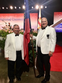PSP Bill Lewis (left) and GEA President Bob Colie (right) pose with the Georgia Flag at the opening ceremony in Tampa, Florida for the Grand Lodge Convention.