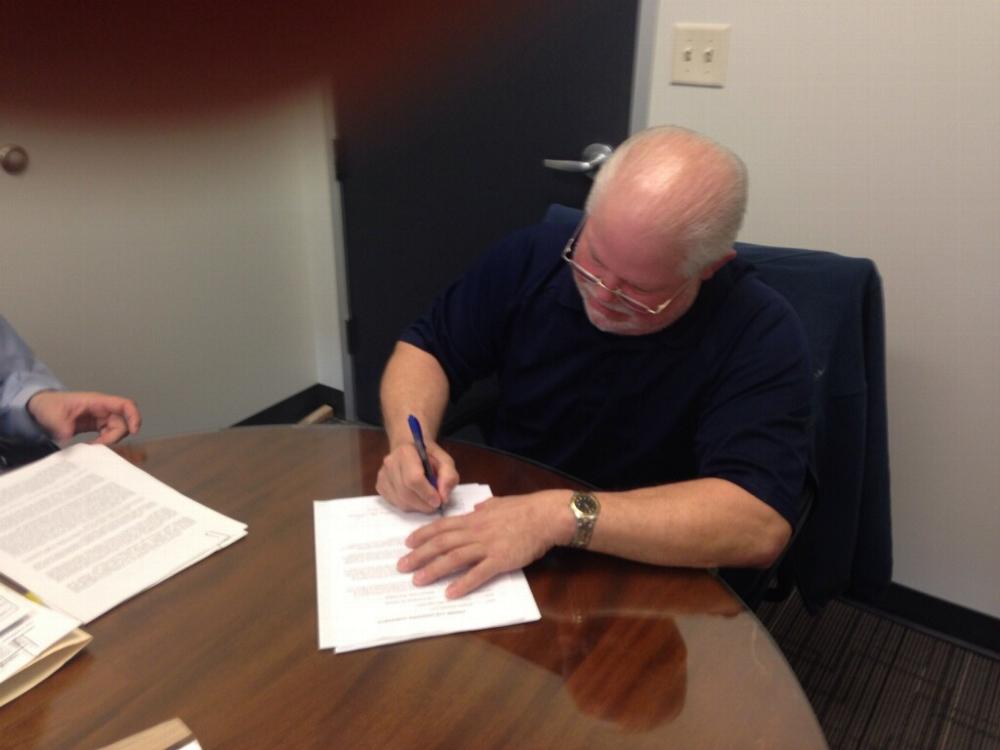Exalted Ruler Joe Corcoglioniti signing the closing documents for our new building!