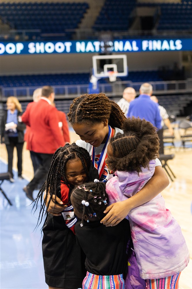 National Champion Kyla Lea hugs her sister and cousins after winning the 10-11 year old contest