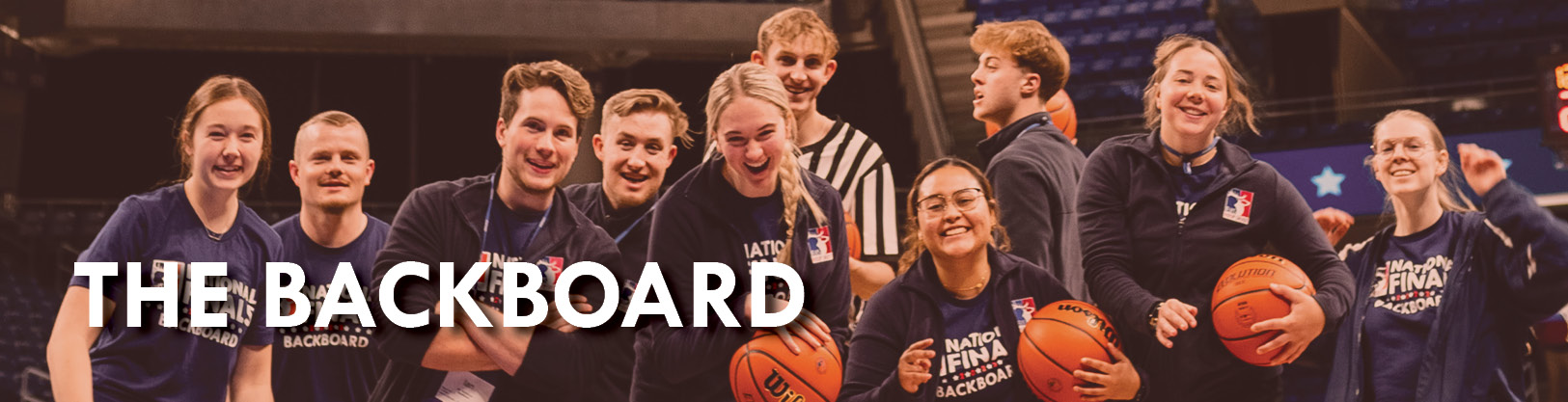  Hoop Shoot BackBoard members smile under the jumbotron at the 2023 National Finals