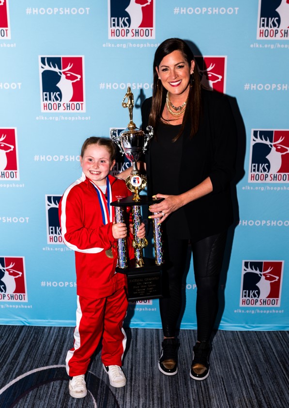 Cadence Watson, who took first in the girls 8-9 division, smiles for a picture with Sarah Spain.