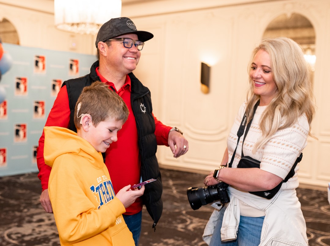 National Finalist Stratton Hallows looks at his trading cards with his parents