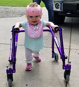 picture of child with helmet on using new adaptive equipment